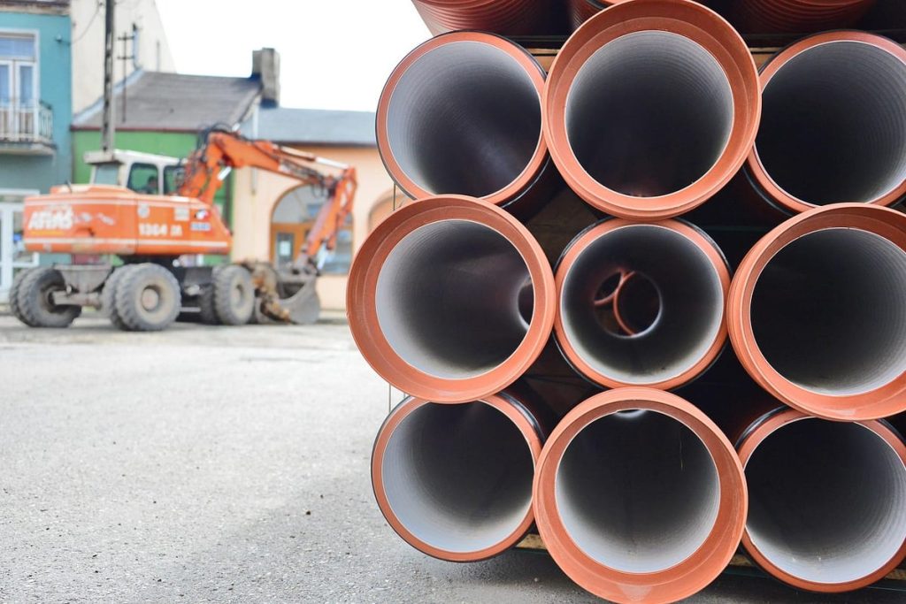 New sewer pipes ready for installation on a job site