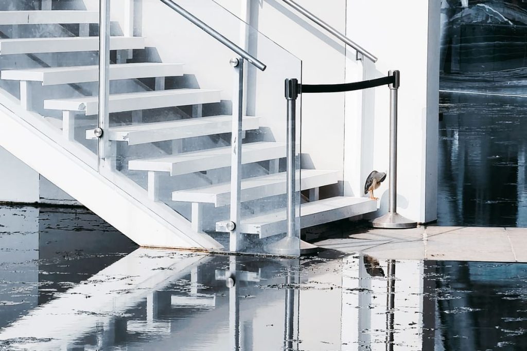 Water flooding the floor at the foot of a staircase