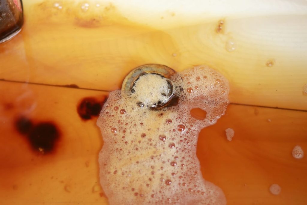 Foamy water backing up around a floor drain