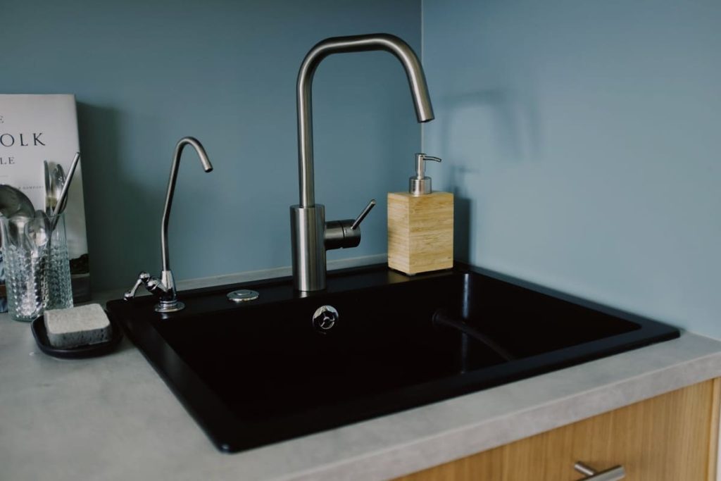Kitchen sink with a faucet and soap dispenser