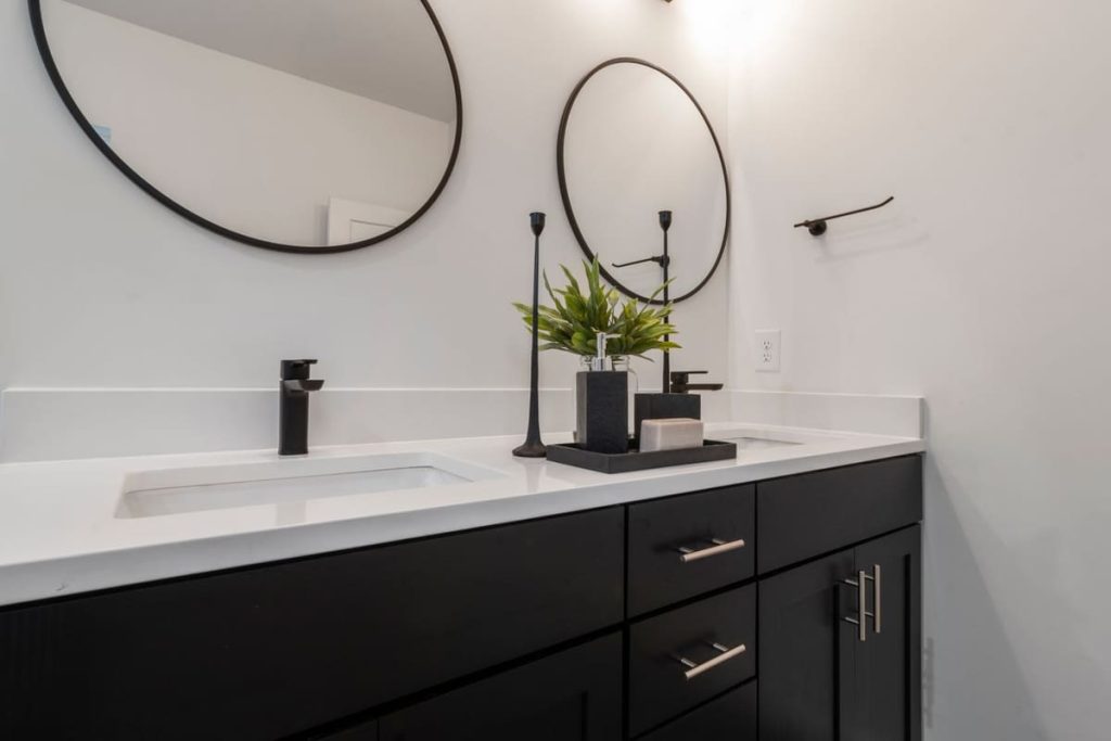 Black and white bathroom vanity with a black faucet