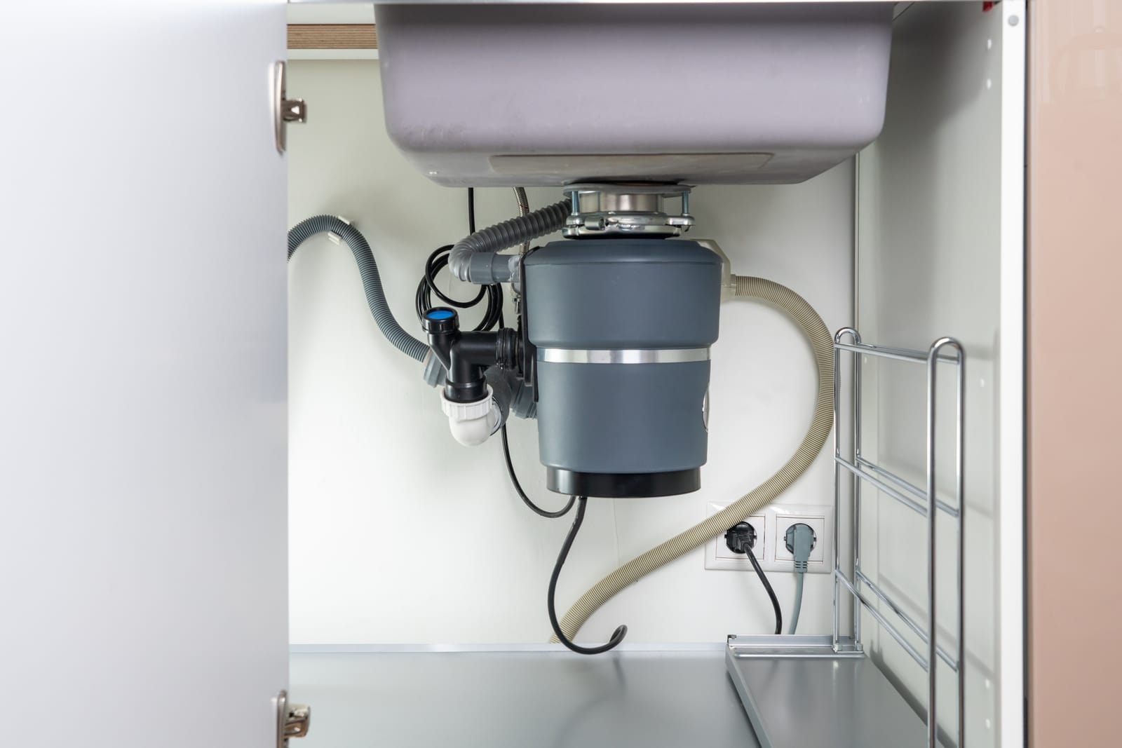 Garbage disposal unit mounted under a kitchen sink