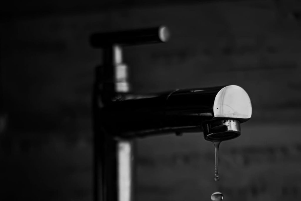 Dripping faucet in black and white