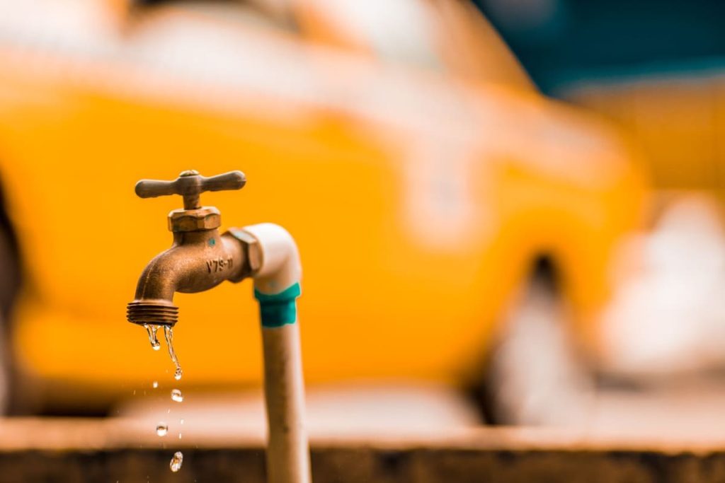 Brass faucet with a water droplet