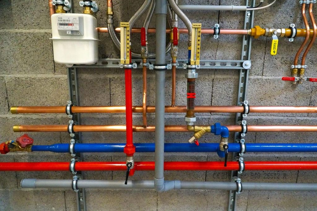 New colour-coded water pipes installed along a wall