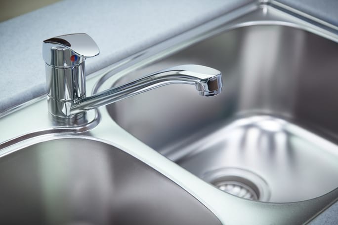 Kitchen faucet over a stainless steel sink