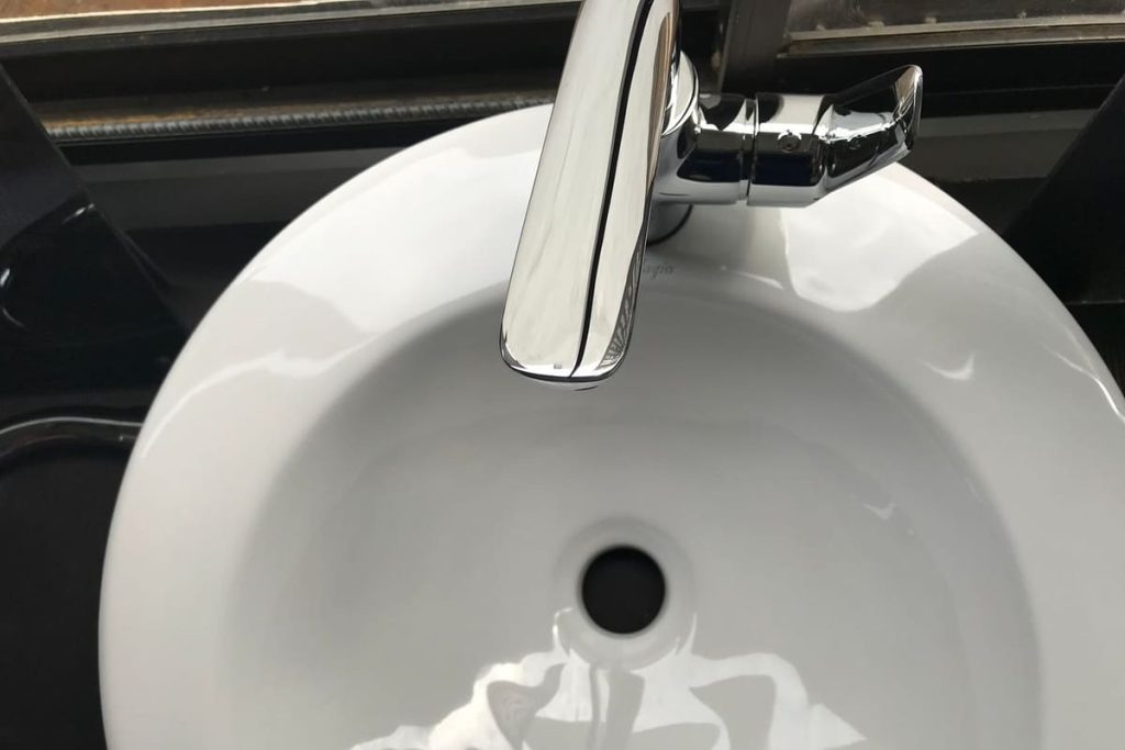 Ceramic sink with a stainless steel faucet