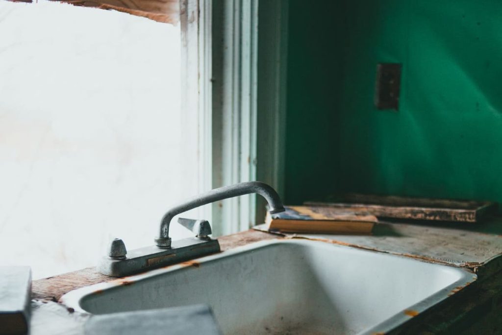Old sink with a tap and corrosion