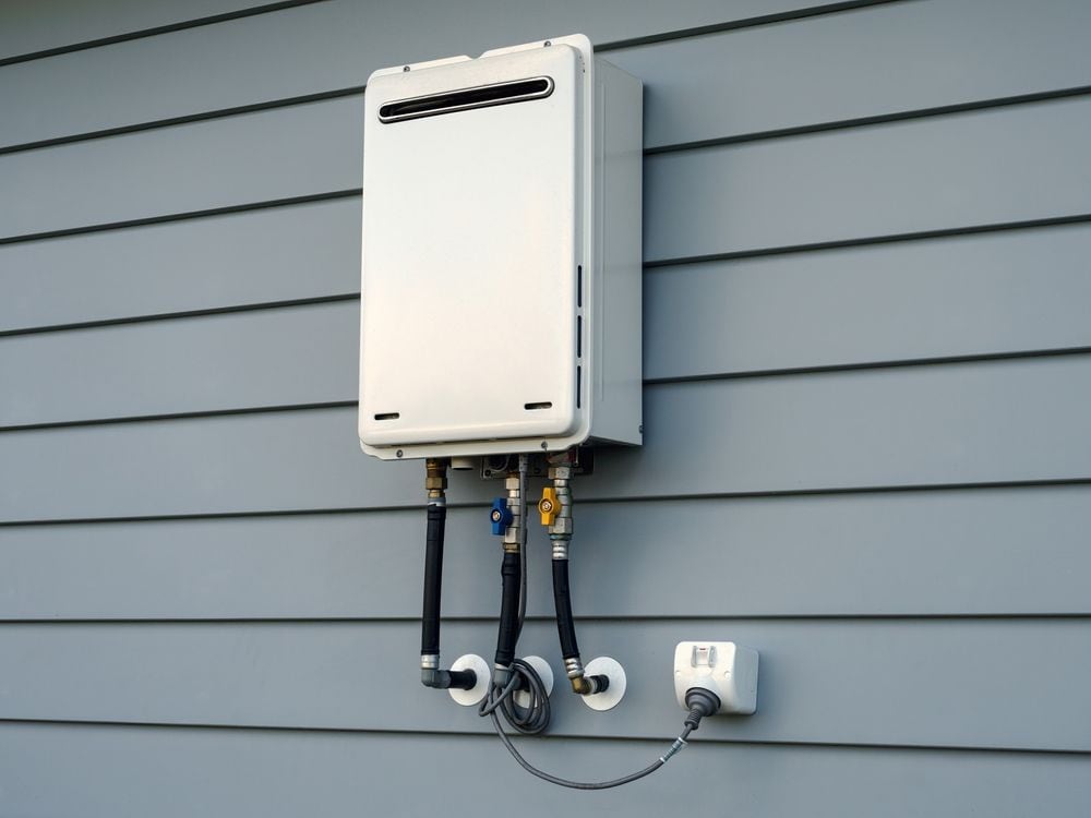 Tankless water heater installed on an exterior wall