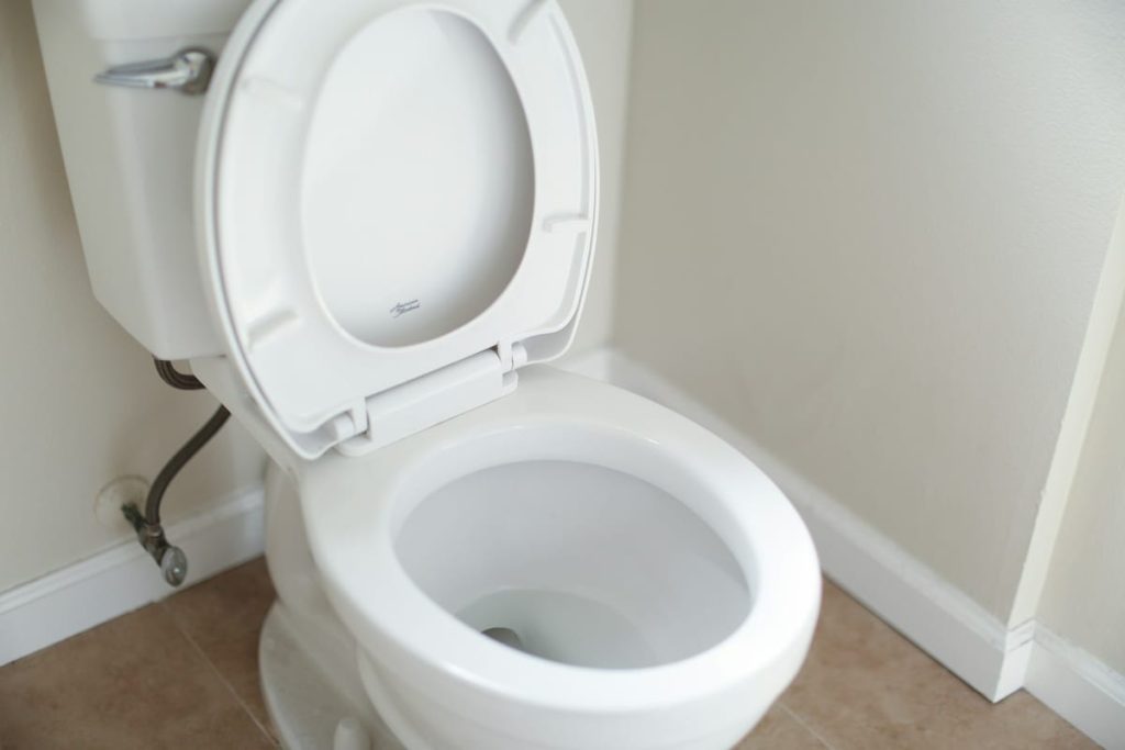 White toilet with its water supply line