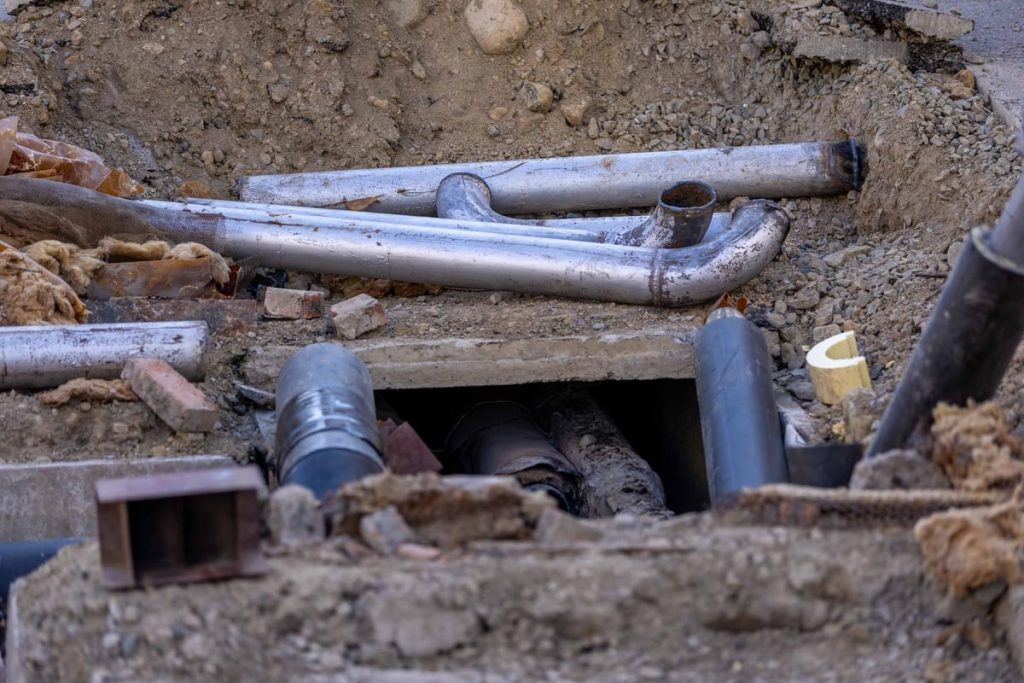 Underground pipes exposed in an access pit