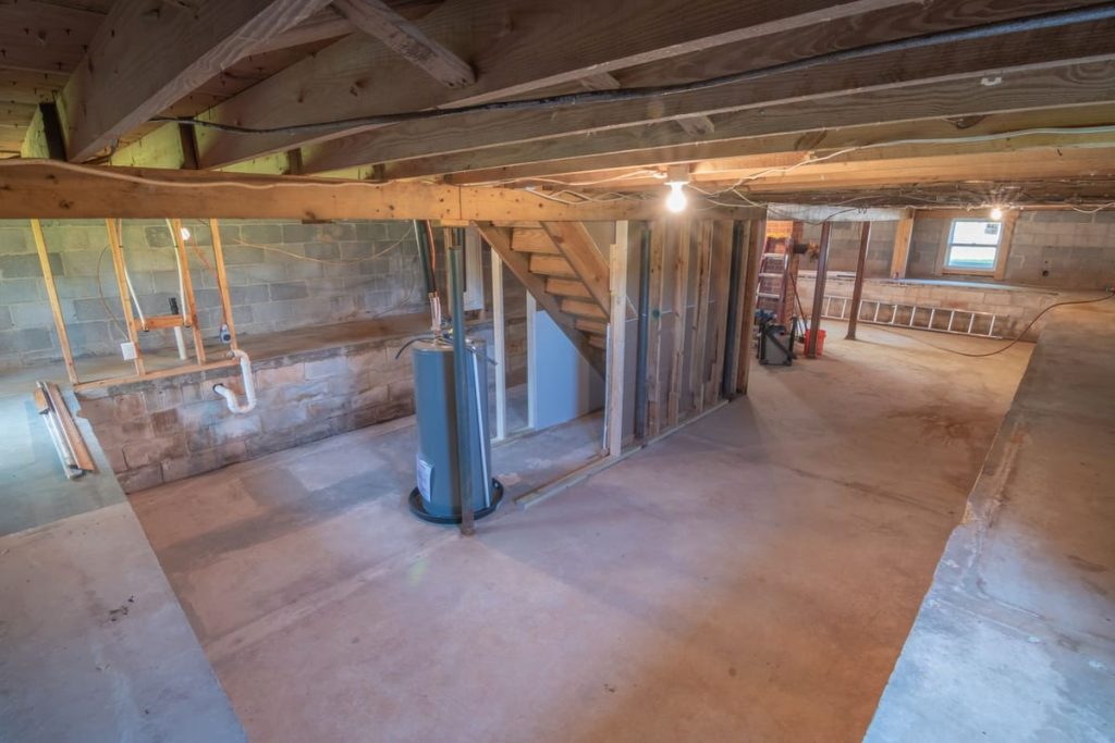 Water heater tank installed in a basement utility area