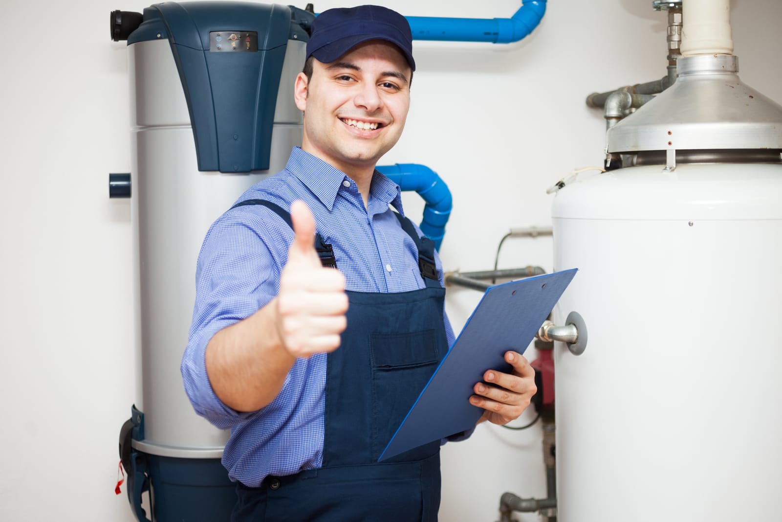 Plumber giving a thumbs up beside a newly installed water heater