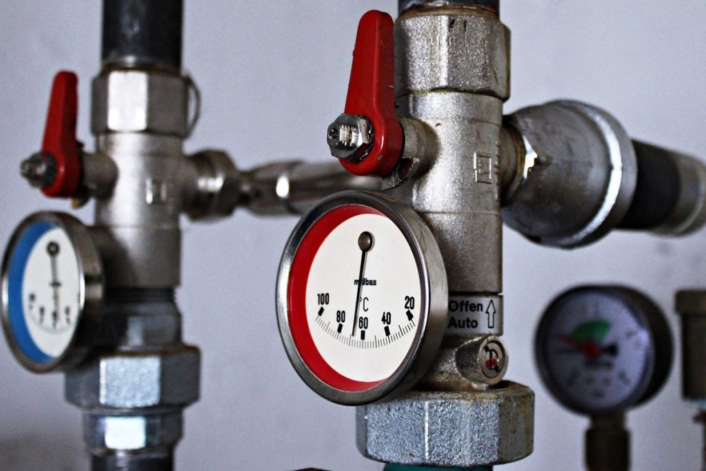 Temperature gauges and valves on hot water pipes