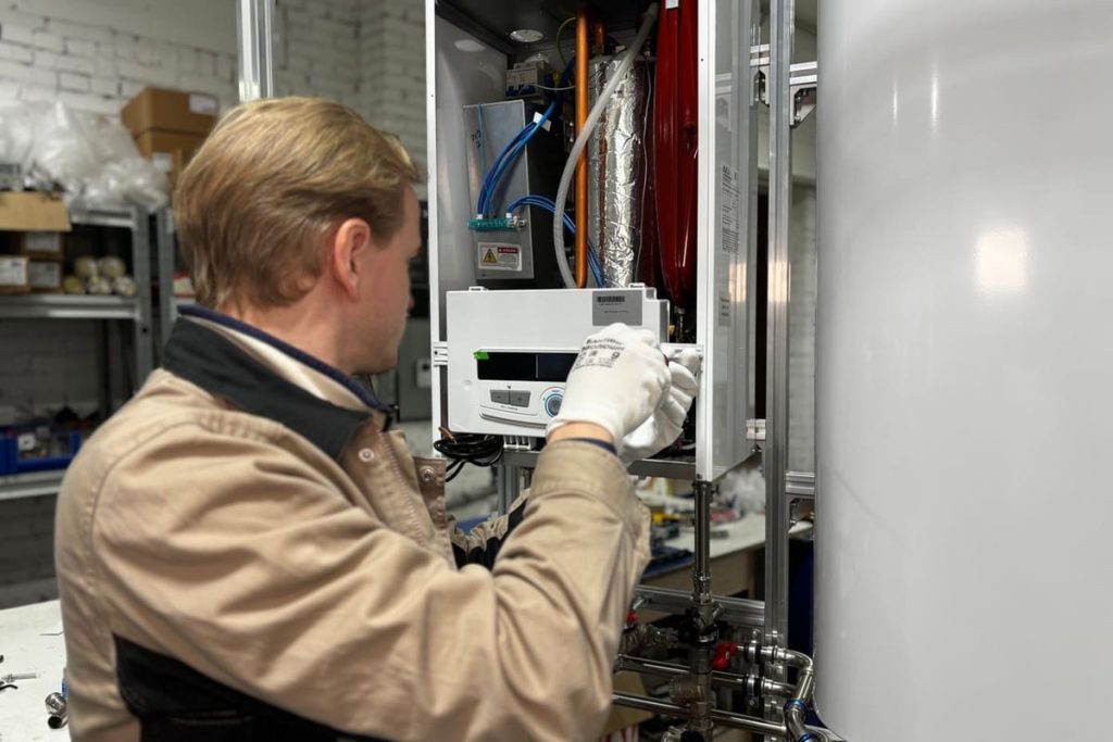 Technician servicing a water heating system