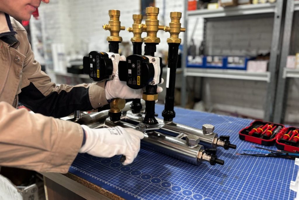 Technician assembling the pump set for a hot water system